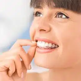 Child flossing teeth with white smile against blue background, dental hygiene care.