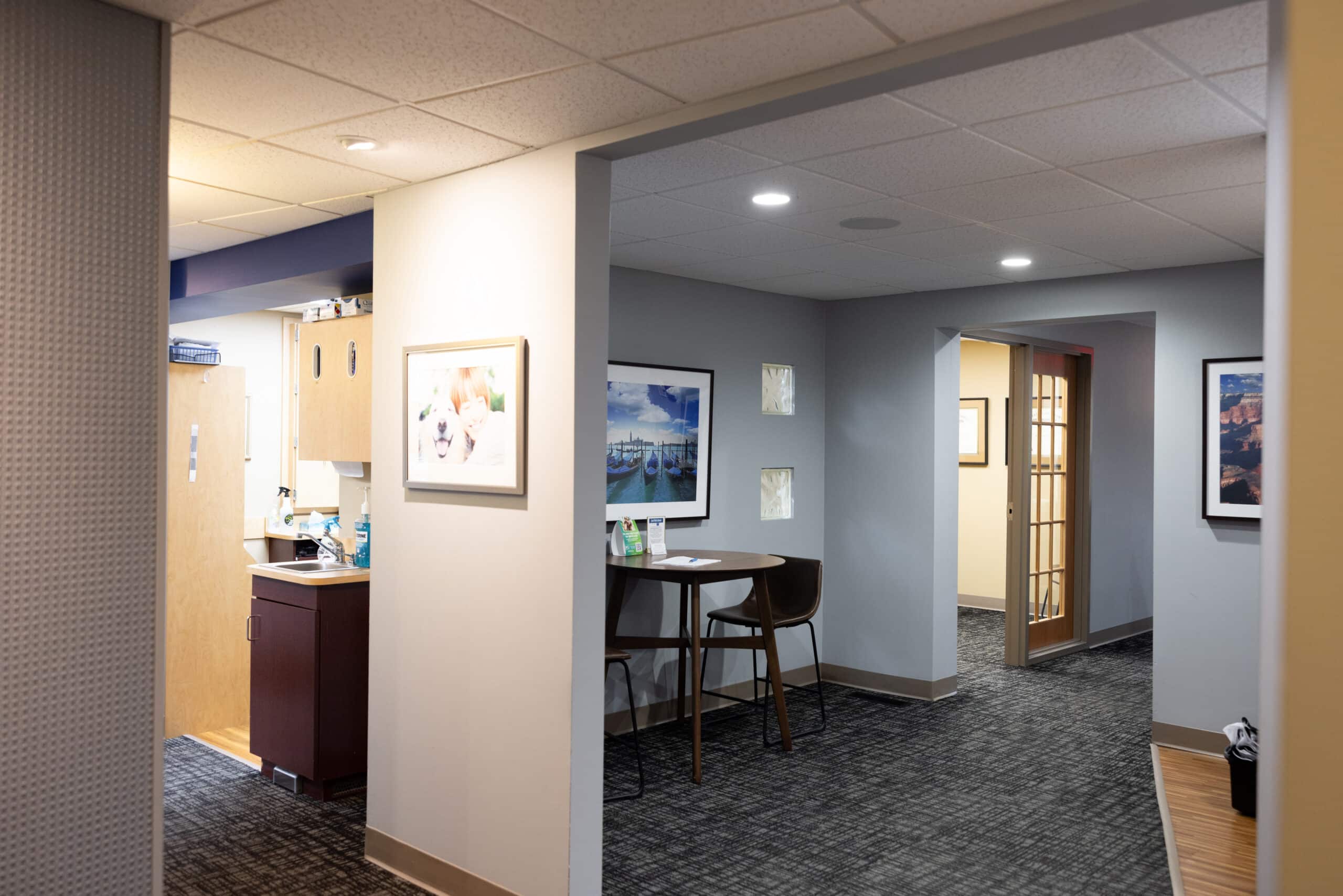 Modern dental office waiting area and hallway with reception desk and contemporary décor.
